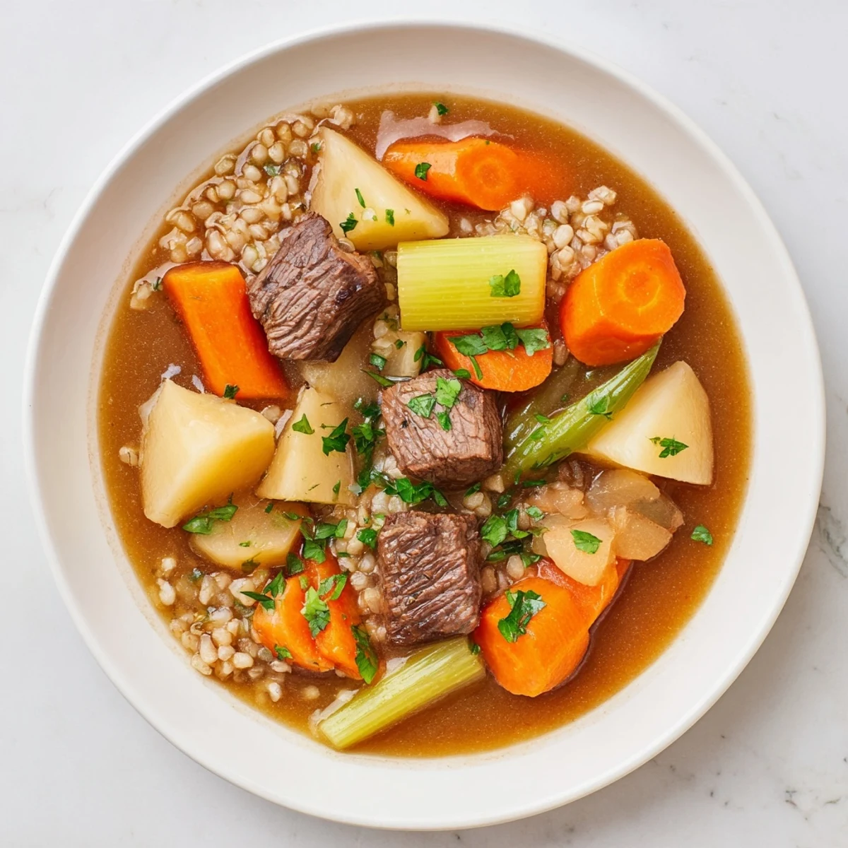 Hearty Irish Stew with Beef and Barley in a rustic pot, garnished with fresh parsley and served alongside crusty bread for dipping.