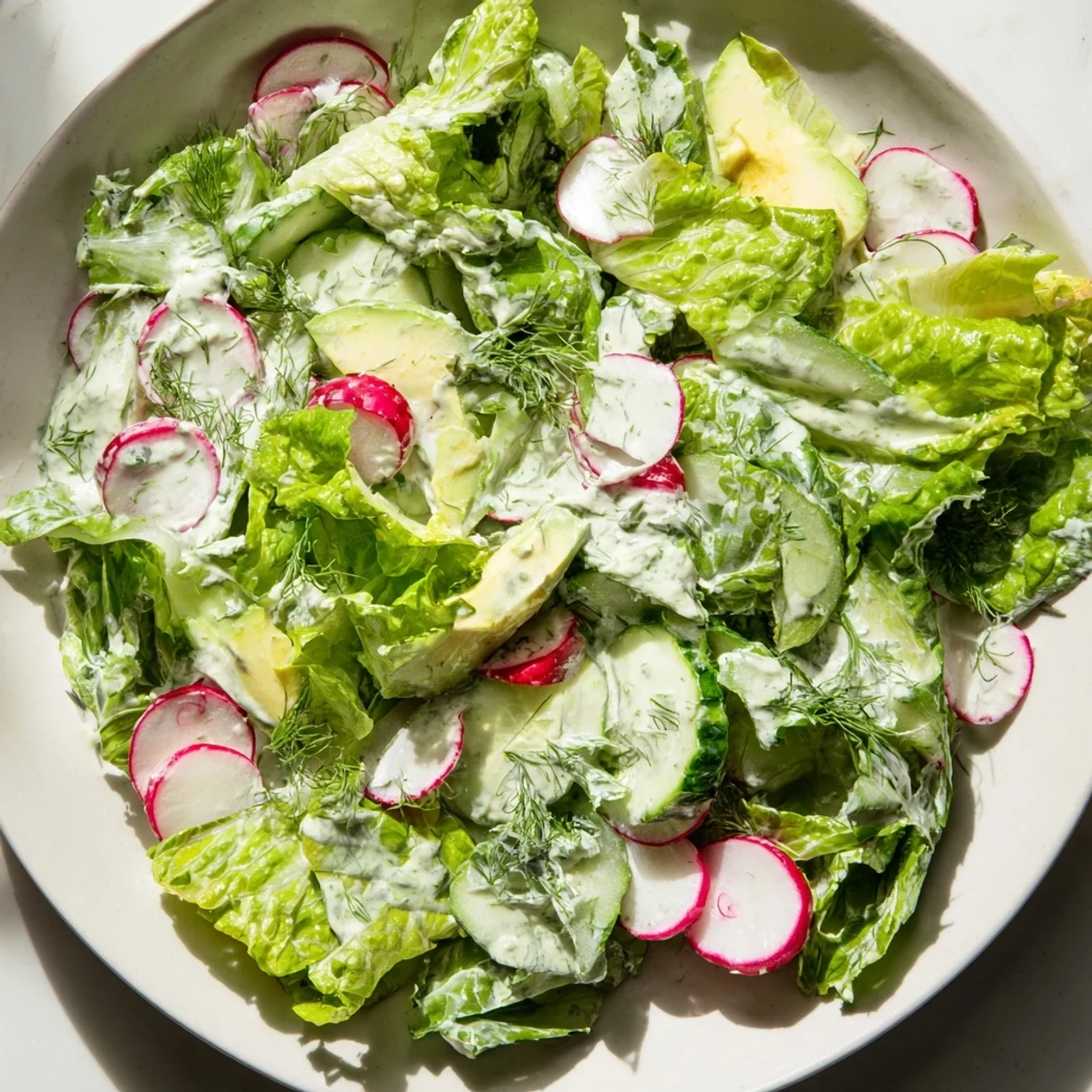 An herbaceous Green Goddess salad with crunchy veggies and herbs, ideal as a light lunch or side dish.
