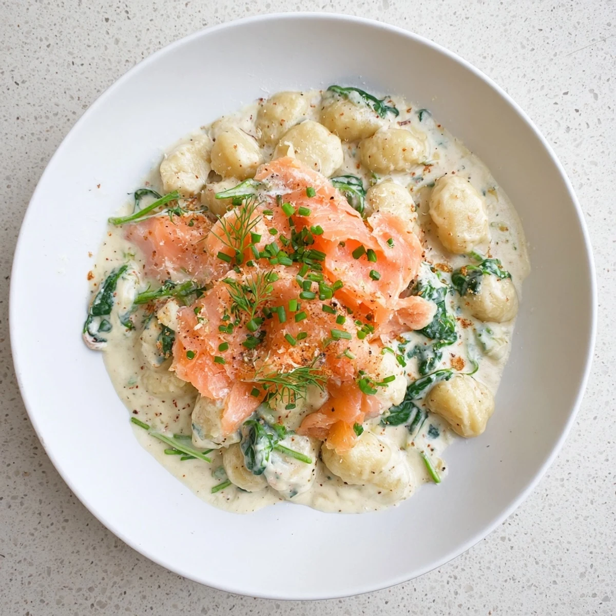 A close-up of Healthy Smoked Salmon Gnocchi featuring creamy sauce and silky salmon pieces.