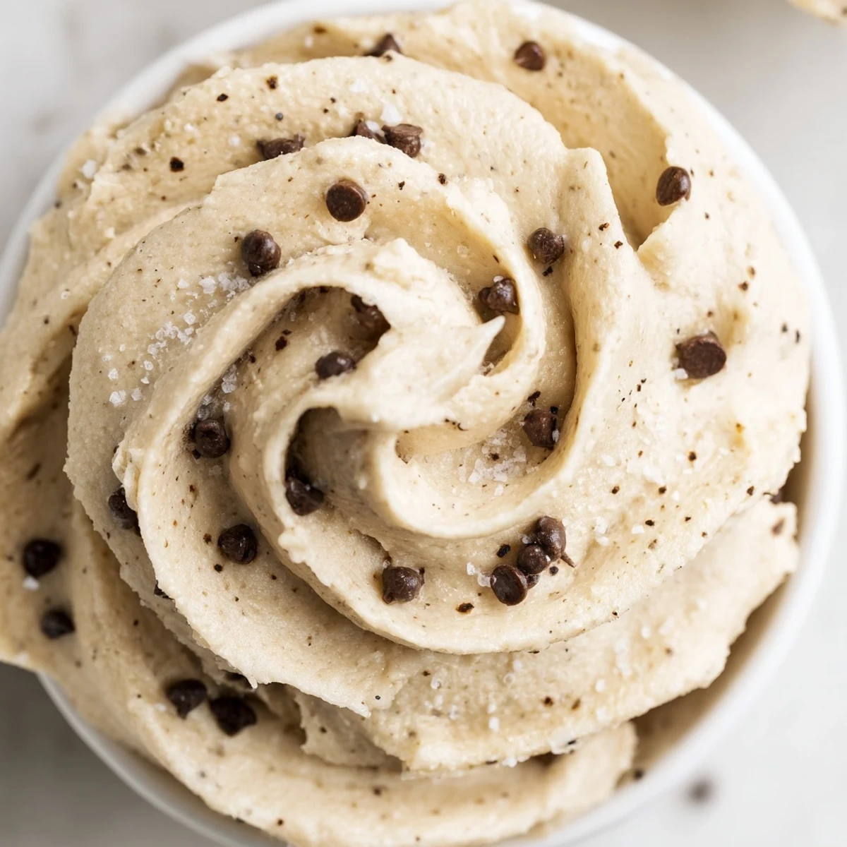 Rich cookie dough frosting ready to spread on a freshly baked cake.