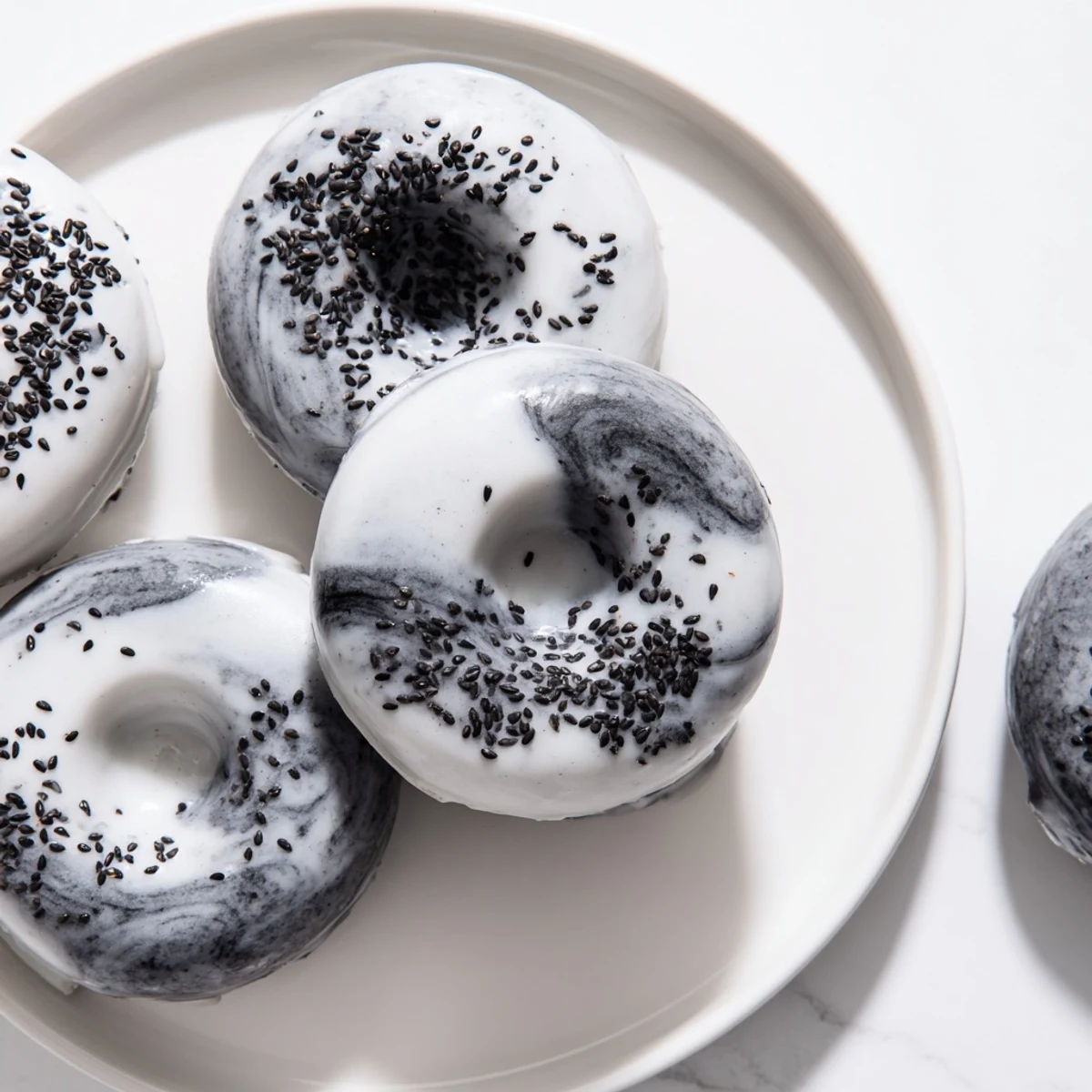 Freshly baked gluten-free Black Sesame Mochi Donuts arranged on a wire cooling rack. 