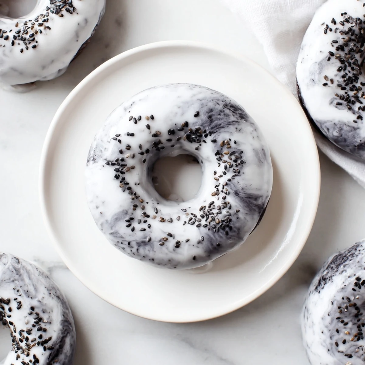 Glazed Black Sesame Mochi Donuts served on a plate, highlighting the nutty, Japanese-inspired dessert.