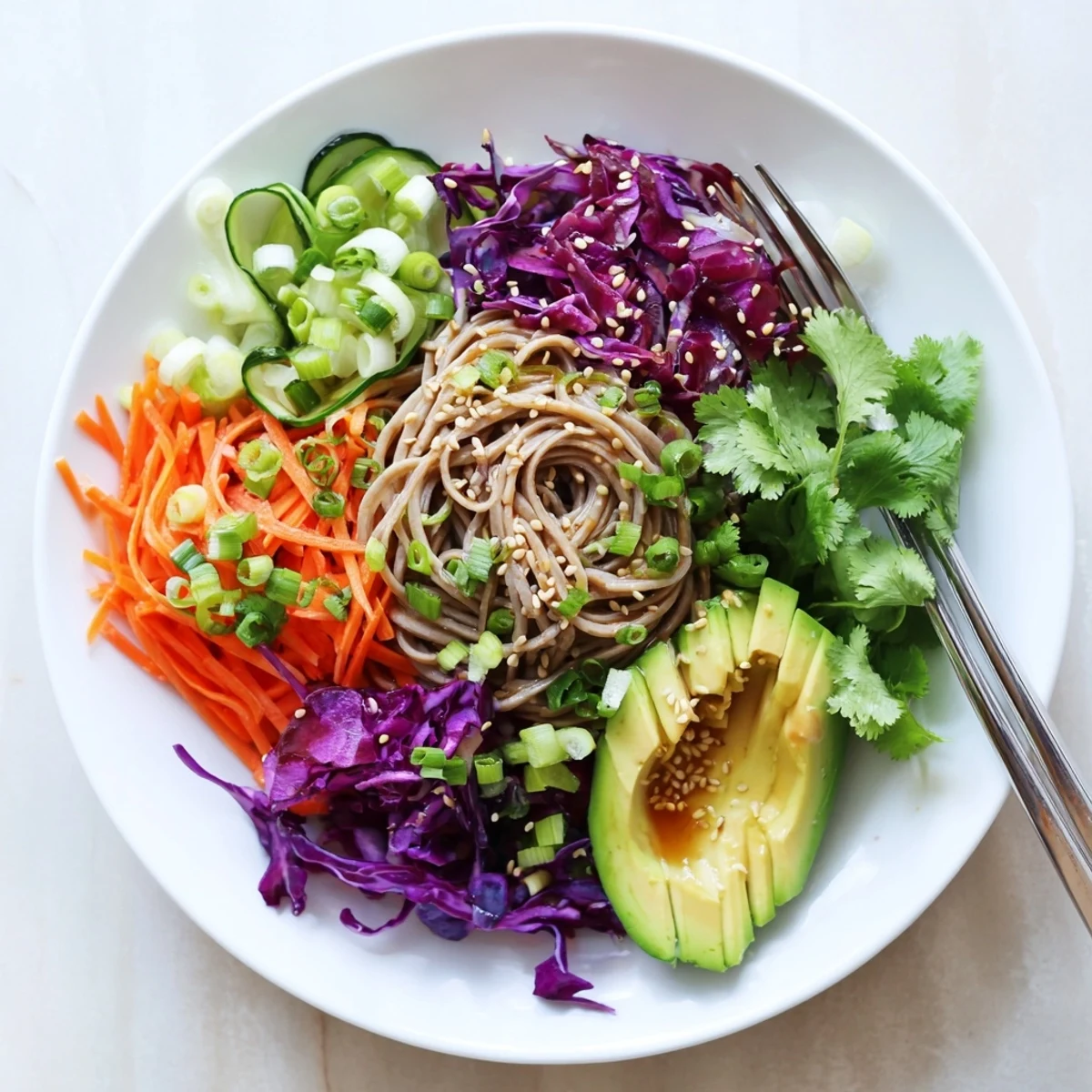 Freshly diced avocado and julienned carrots mix with soba noodles in this vibrant sesame avocado and soba noodle salad.