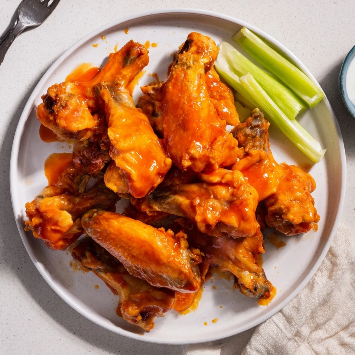 Freshly prepared Crispy Smoked Buffalo Wings tossed in buttery hot sauce, ready to be enjoyed at a game day gathering.