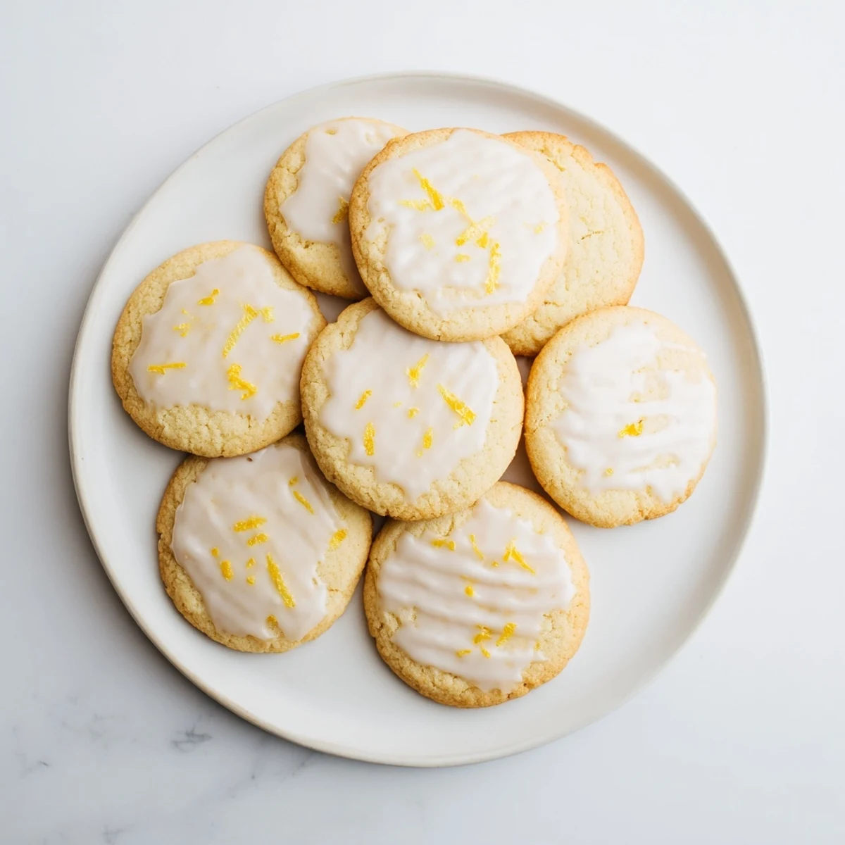 Golden buttery Limoncello Cookies on a wire cooling rack, dusted with lemon zest and ready for a tea party.