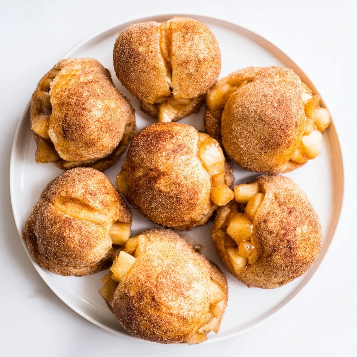Golden caramel apple pie bombs featuring spiced apple filling and melted caramel centers
