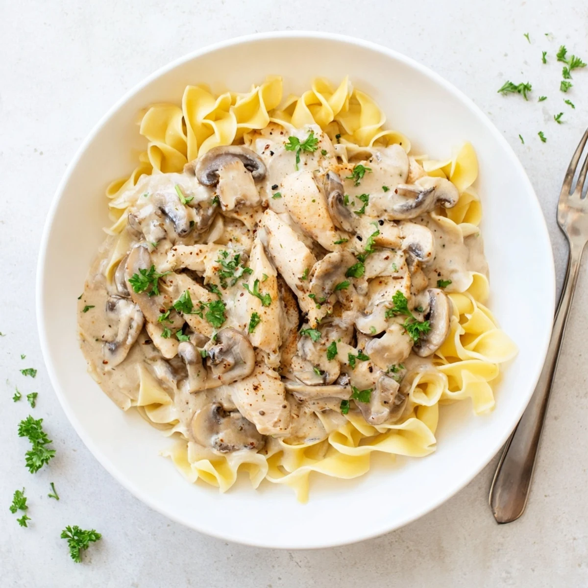 Golden brown chicken strips simmered in rich creamy stroganoff sauce with sliced mushrooms
