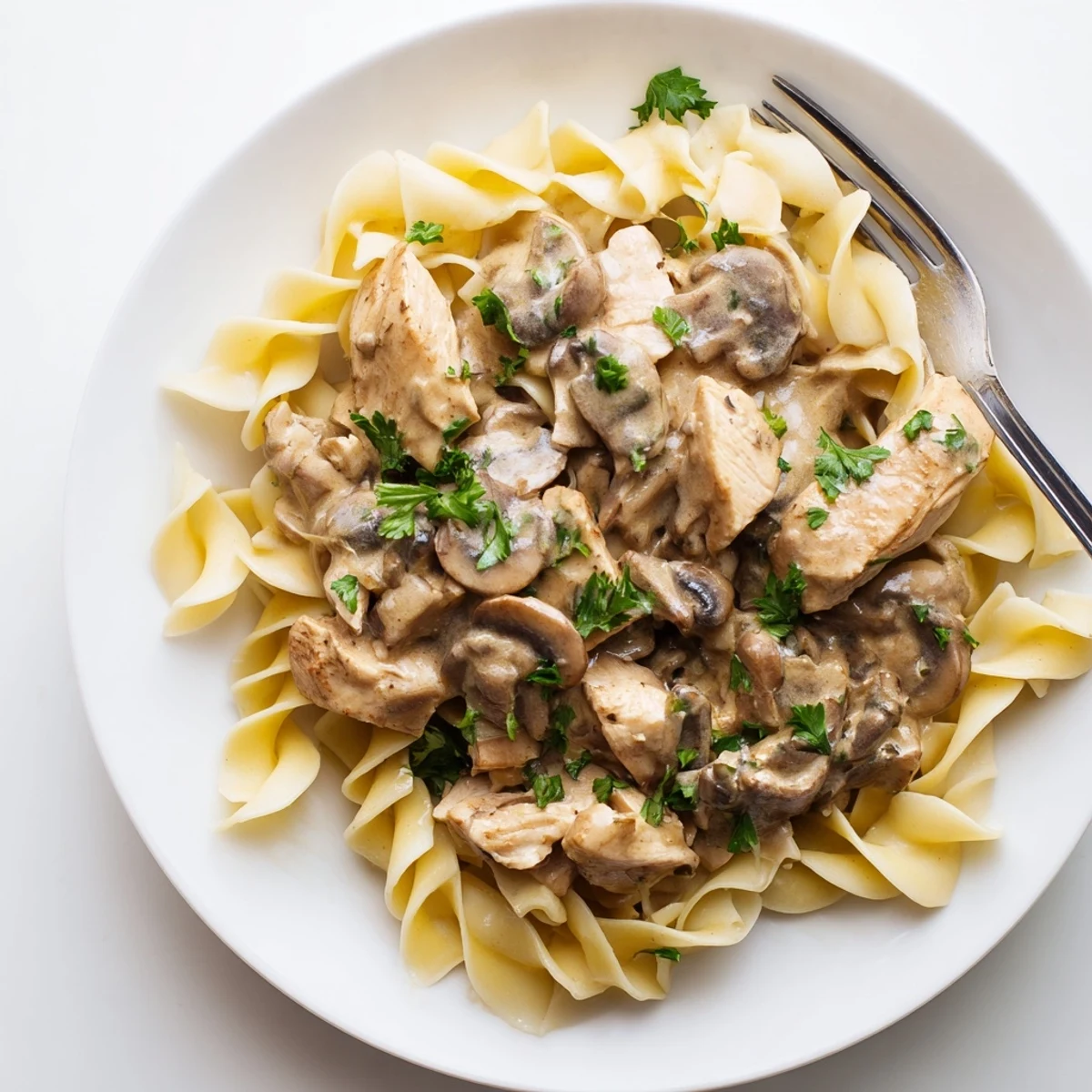 Creamy sour cream sauce coats tender chicken and mushrooms in this savory chicken stroganoff