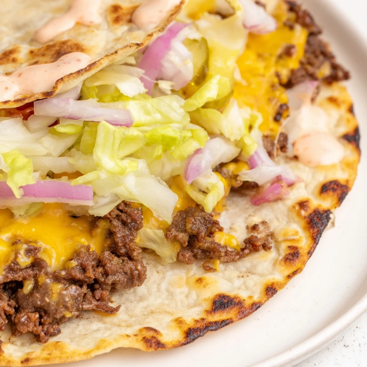 Juicy beef Smash Burger Tacos folded in soft flour tortillas with crisp lettuce and pickles