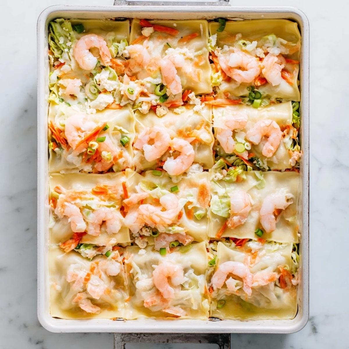 Layered shrimp dumpling lasagna showcasing tender shrimp and ricotta between square dumpling wrappers