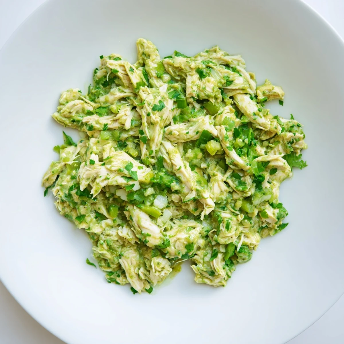 Golden chicken pieces bathed in tangy green salsa ready for warm corn tortillas