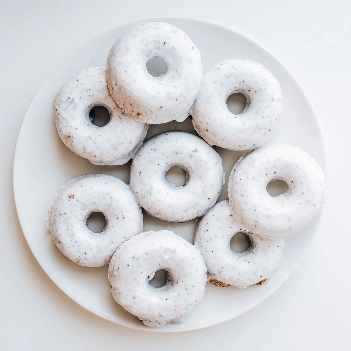 Batch of freshly baked Earl Grey mochi donuts cooling on a wire rack with glossy glaze