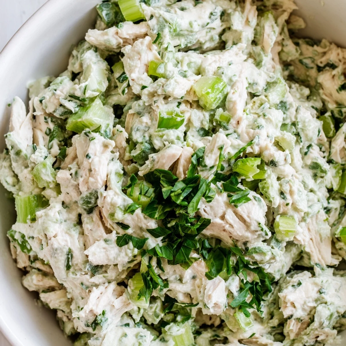 Green Goddess Chicken Salad Dip plated with fresh vegetables, showcasing its creamy herb-filled texture
