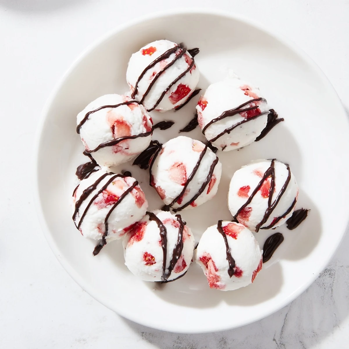 Close up of strawberry high protein yogurt bites with red fruit pieces visible