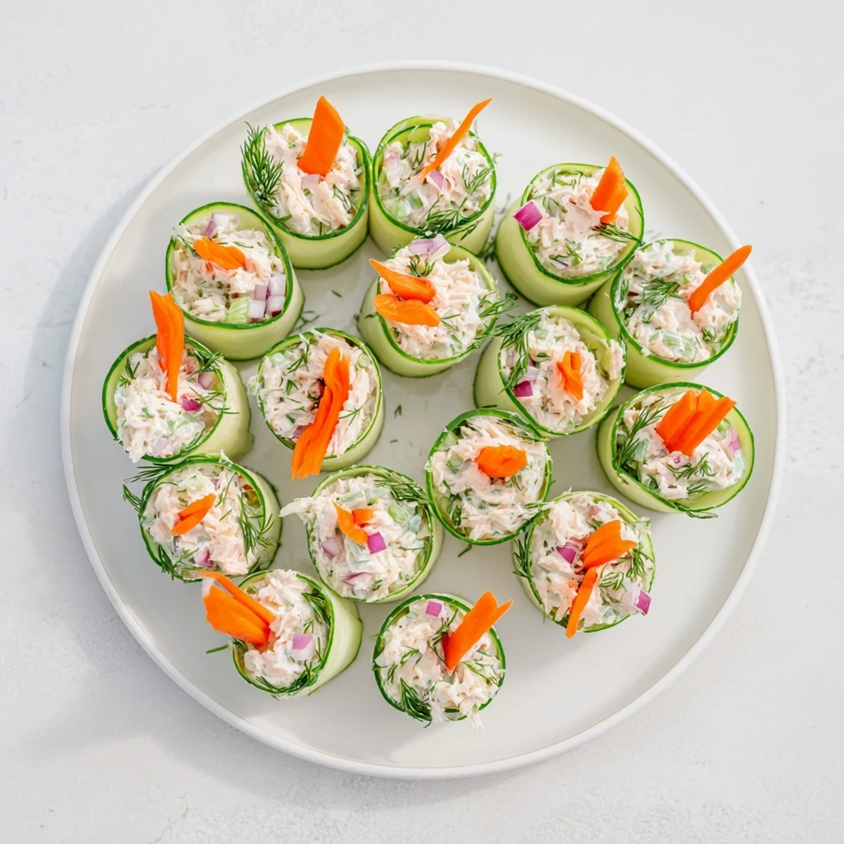 Fresh cucumber slices rolled around creamy chicken salad create a light, refreshing appetizer