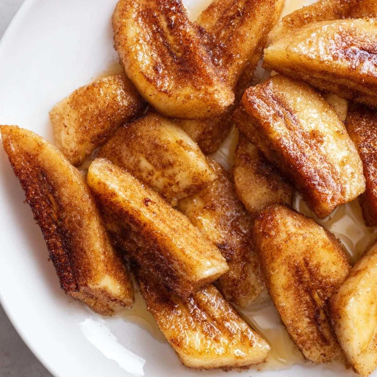 Golden pan fried cinnamon bananas caramelized to perfection in a skillet