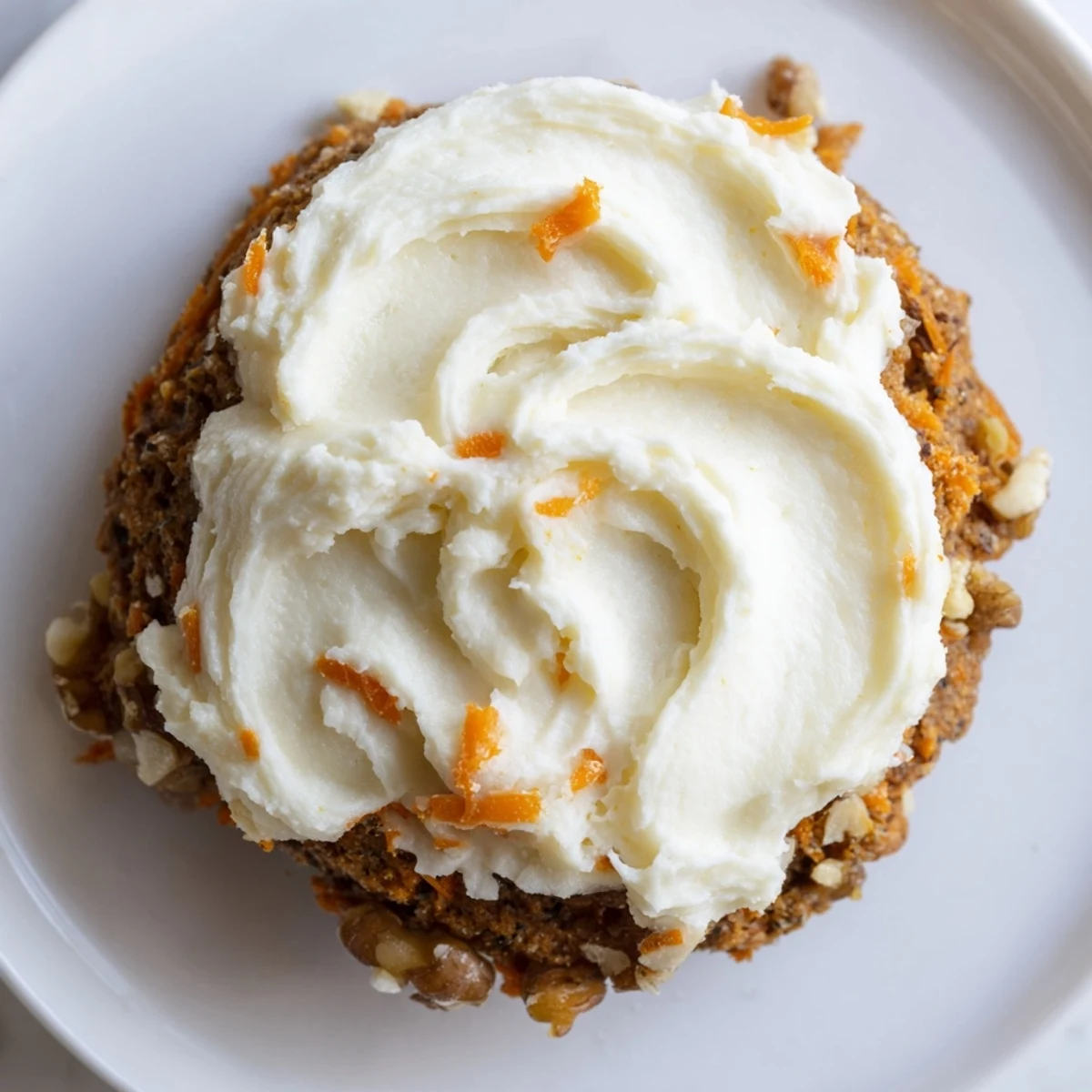 Soft frosted Crumbl carrot cake cookies with swirls of tangy cream cheese frosting