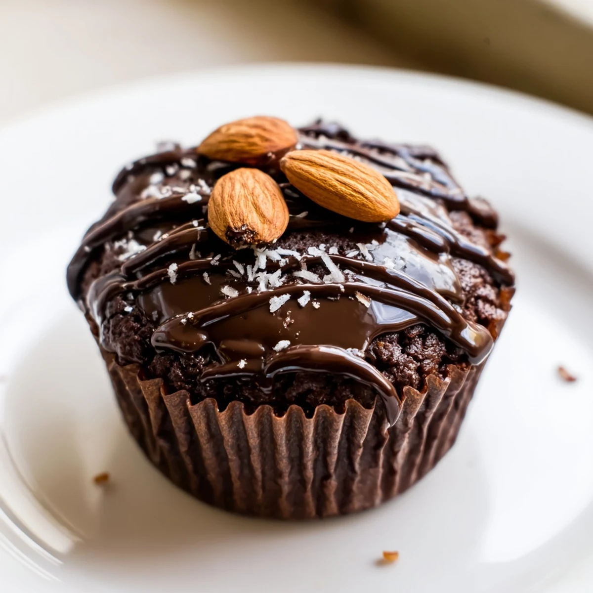 Gluten-free Flourless Almond Joy cupcakes with gooey coconut centers, beautifully plated for a decadent American dessert