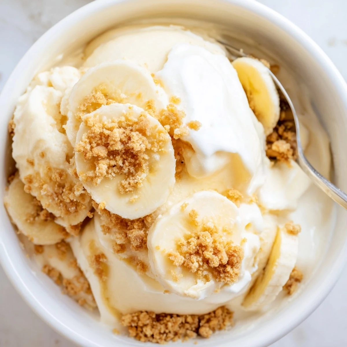 Creamy Ninja Creami Banana Cream Pie Ice Cream topped with whipped cream  