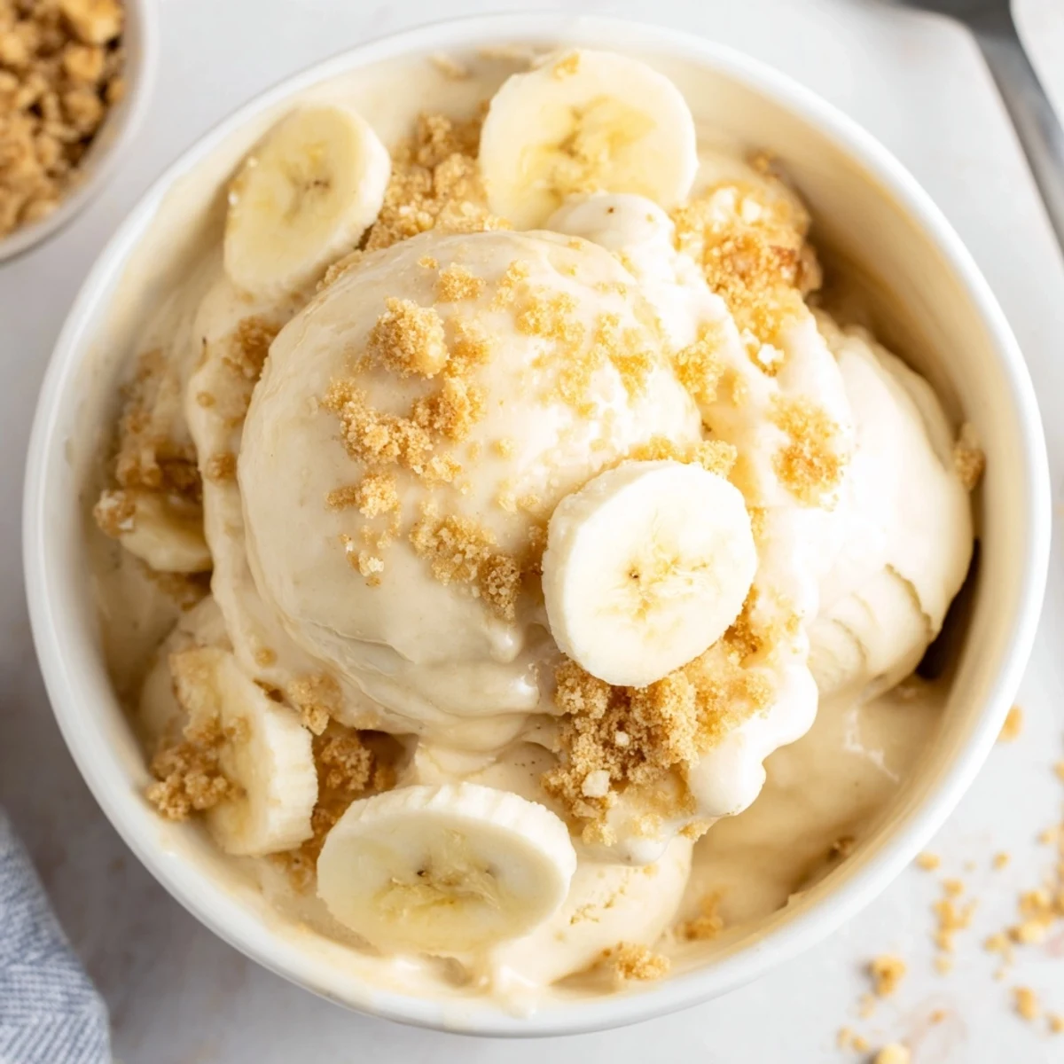 Silky Ninja Creami Banana Cream Pie Ice Cream swirled with buttery graham crumbs  