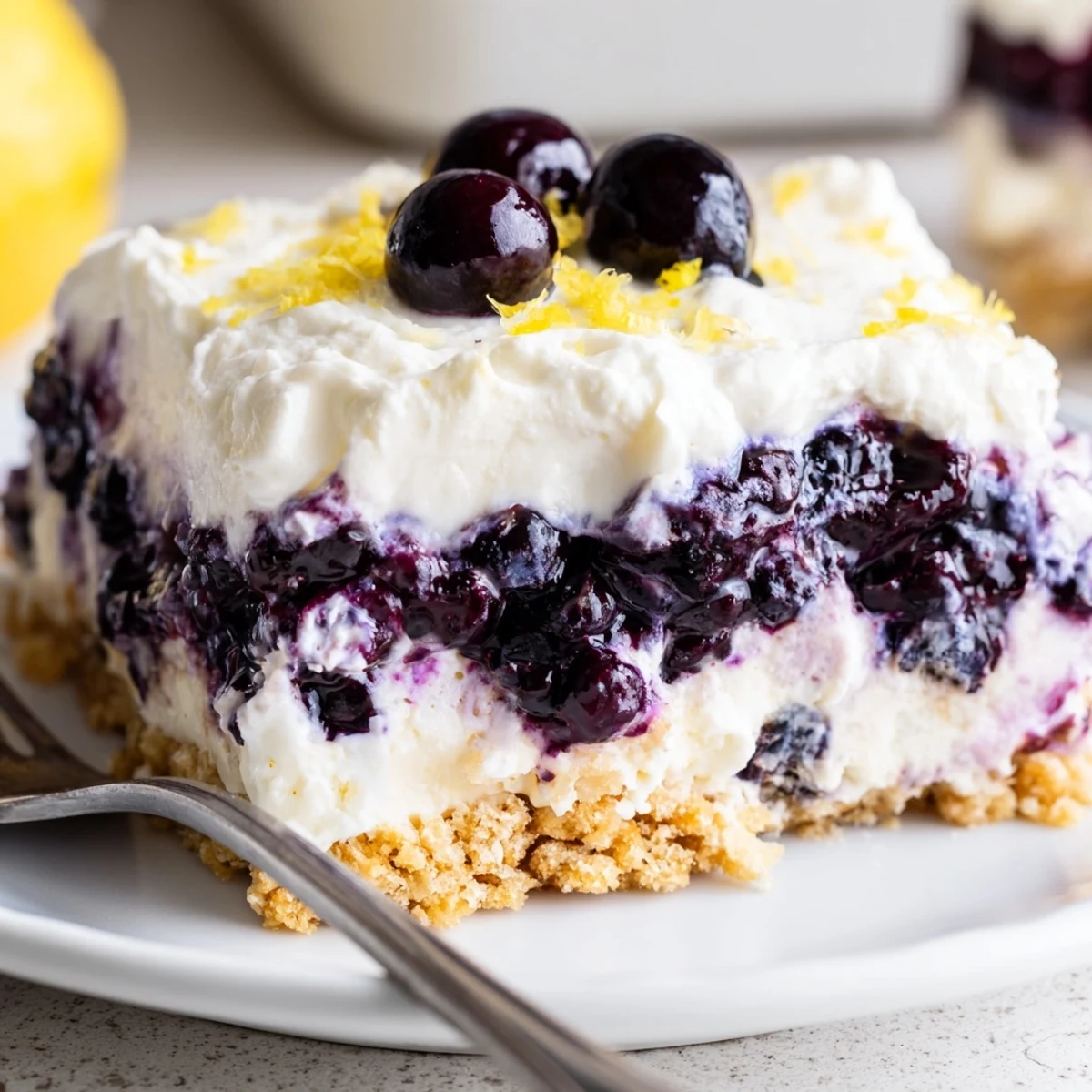 Lemon Blueberry Lasagna Recipe showing chilled layers of creamy lemon and glossy blueberries