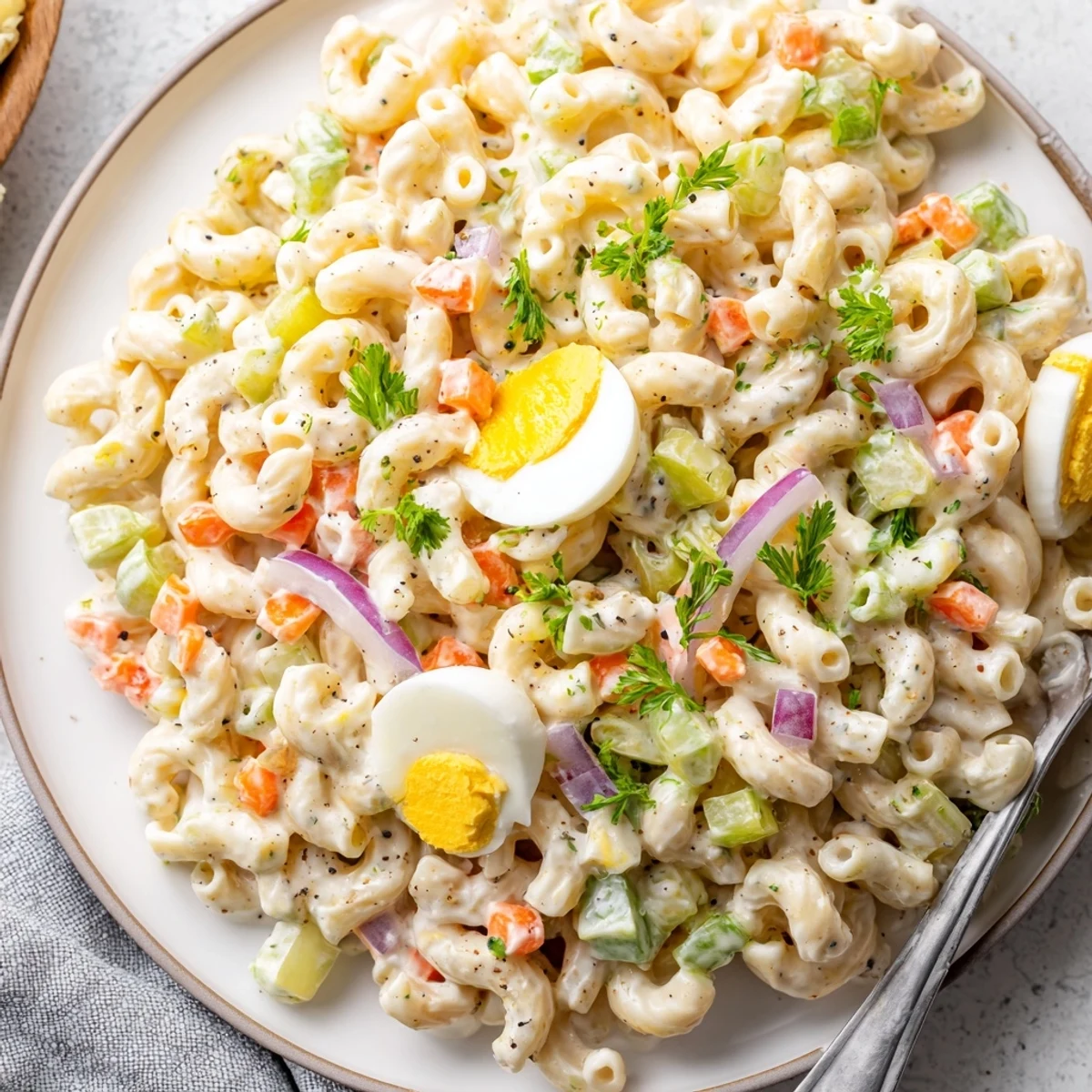Chilled Macaroni Salad tossed with tangy Dijon dressing, peas and shredded carrots