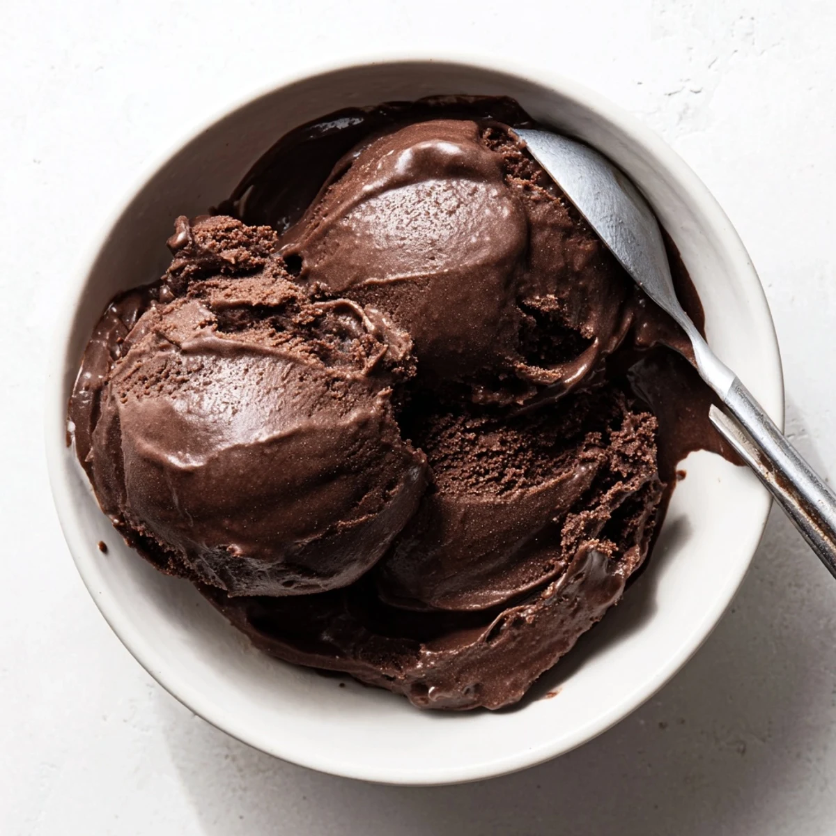 Dark chocolate sourdough ice cream served in vintage glass bowl with sea salt garnish