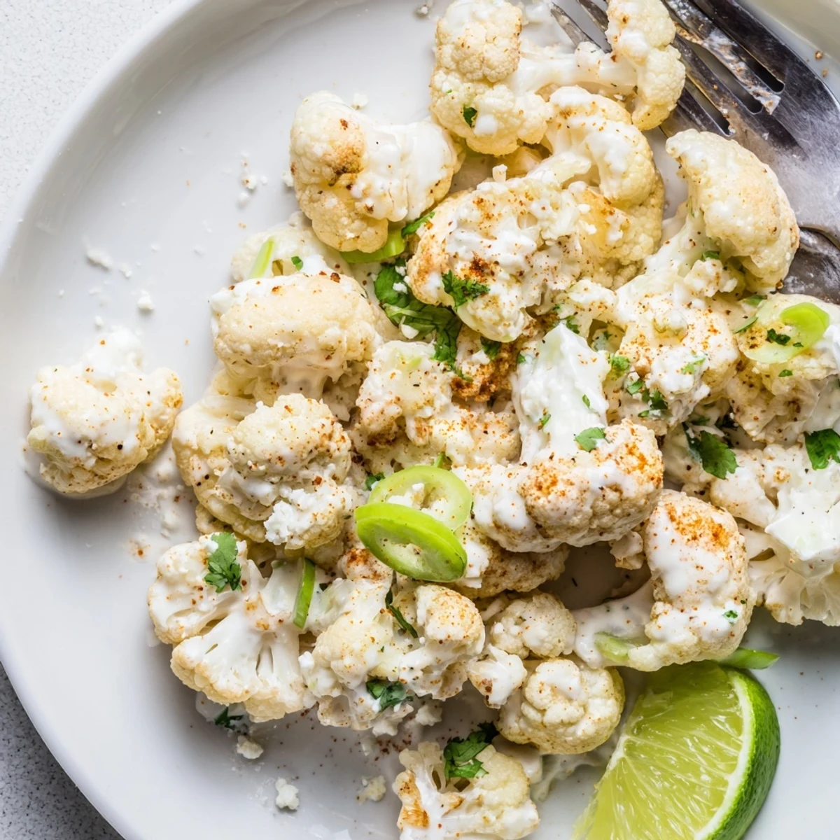 Crispy roasted Cauliflower Elote tossed in tangy sauce, sprinkled with cilantro.