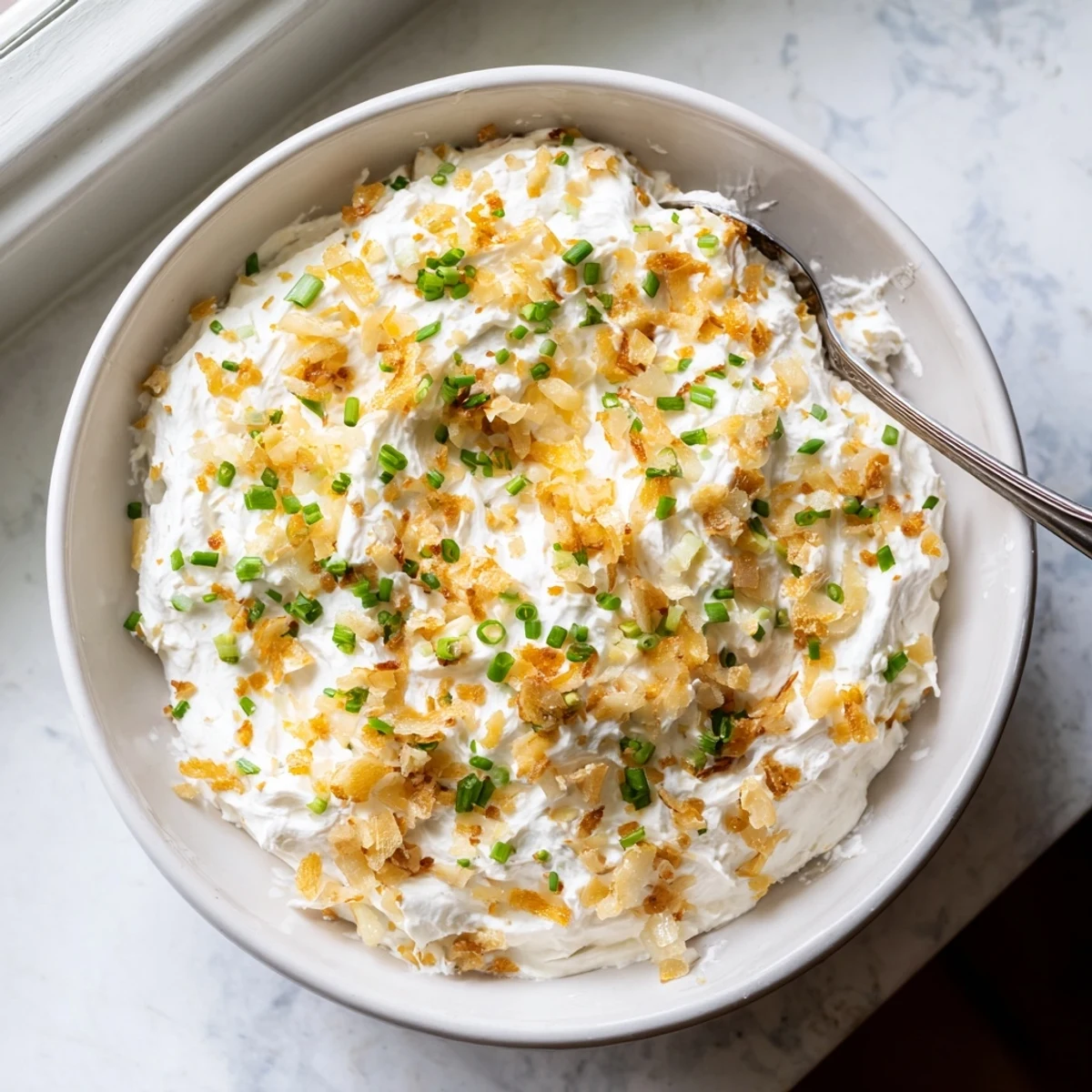 Savory French onion dip featuring sweet caramelized onions blended into a smooth cream base
