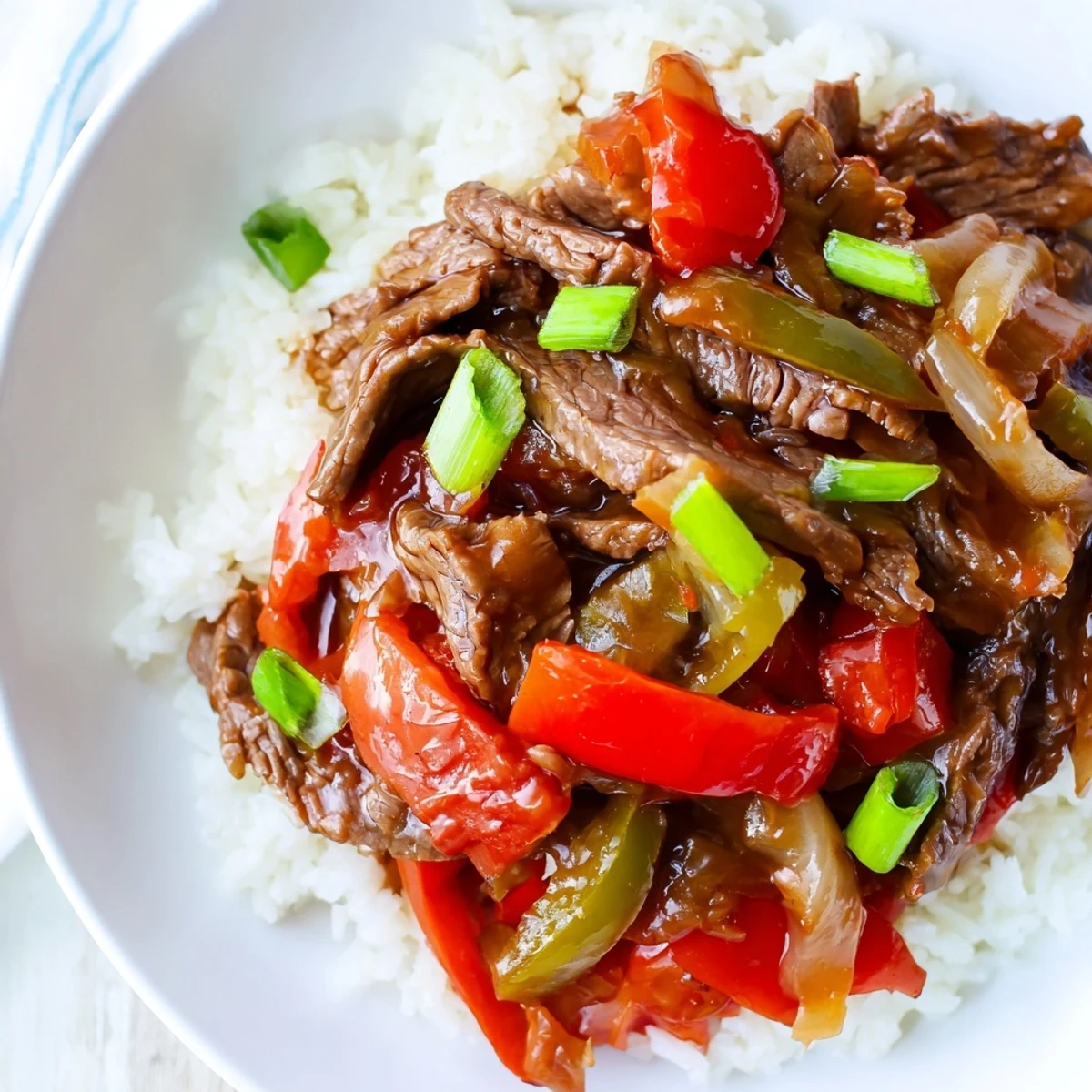 Slow Cooker Pepper Steak with tender beef strips and colorful bell peppers in rich savory sauce