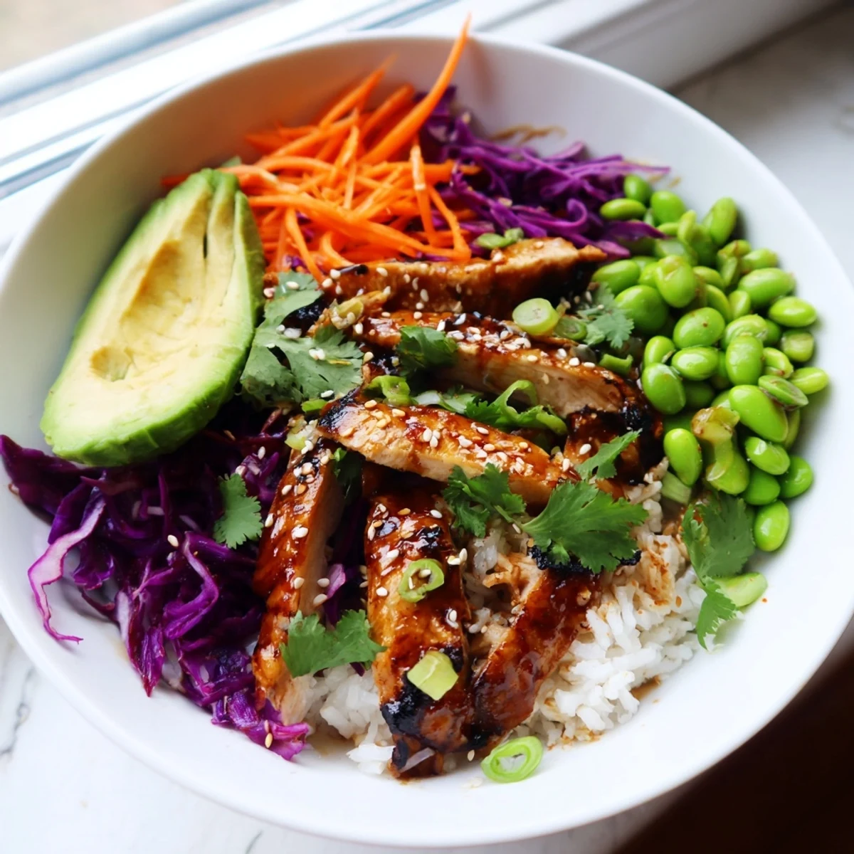 Asian Inspired Chicken Power Bowl layered with crisp vegetables and drizzled sesame-ginger dressing