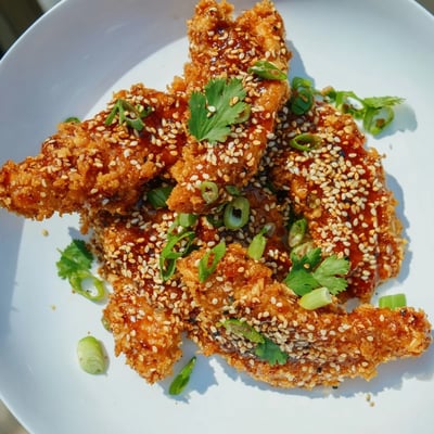 Oven-baked chicken tenders coated in crunchy panko then tossed in a tangy Thai chili glaze with fresh herbs