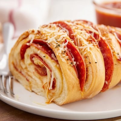 Pepperoni Pizza Roll Breadsticks Recipe served steaming with marinara, buttery Parmesan crust